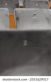 Rows of empty seats in a cinema hall,  front side of the seats with numbers. Close-up with shallow depth of field 