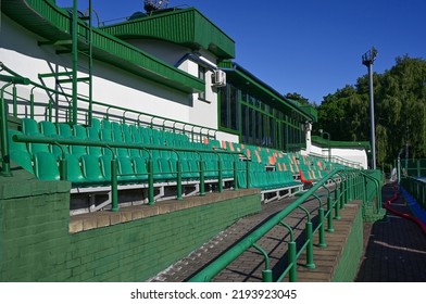 Rows of empty seats of a small outdoor sports stadium on a sunny summer day