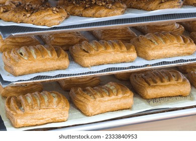 Rows of fresh bread loafs lying on the shelf