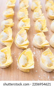 Rows Of Homemade Wontons On Wood Worktop