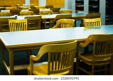 Rows of institutional chairs and tables in learning environment. The typical American environment for large group learning and meeting and interacting. High quality photo