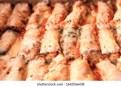 Rows Of Italian Ricott Manicotti Pasta Tubes, Ridged, Stuffed And Baked