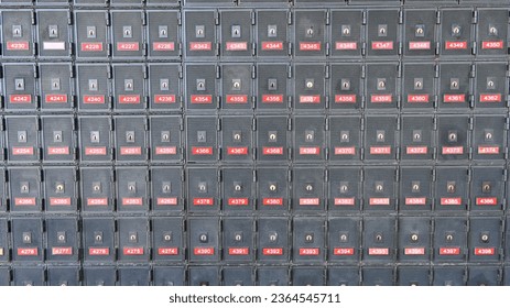 Rows of metal post office boxes on a wall in the post office