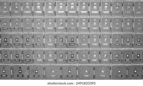 Rows of metal post office boxes on a wall in the post office