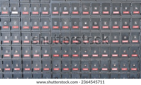 Rows of metal post office boxes on a wall in the post office