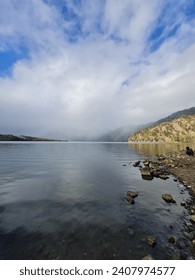Rows of mountains and their reflections on the lake