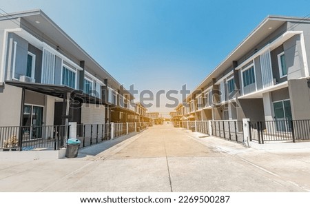 The rows of new townhouses, view of the houses with paved roads in the middle , the architectural design of the exterior, The concept for Sale, Rent, Housing, and Real Estate