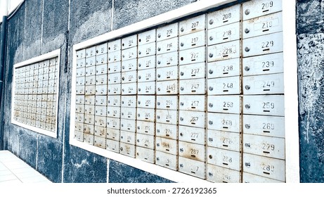 Rows of numbered mailboxes embedded in concrete