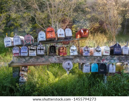 Rows of old colorful mailboxes in a rural setting