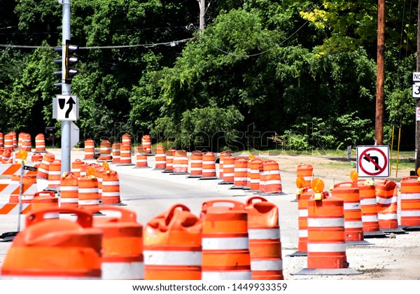 Rows and rows of orange barrels to\
guide traffic through a road construction project.\
