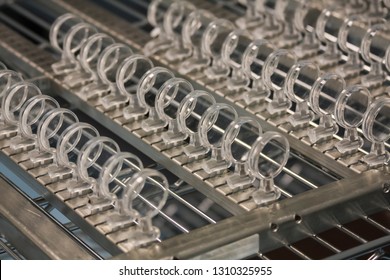 Rows of Plastic Lenses in a Manufacturing Plant. Can be used for technology, optical engineering careers, molded plastics industry.