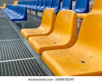 Rows of plastic seats at a stadium. empty coloured plastic seats row at sport stadium. stadium seats background. Empty Rows of Plastic Seats at Stadium
