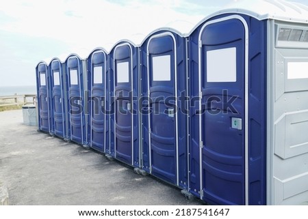rows of portable toilet outdoor        