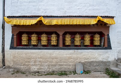 Rows of prayer wheel on the wall in Kathmandu city of Nepal. The words mantra "Om Mani Padme Hum" is written in Sanskrit on the outside of the wheel.