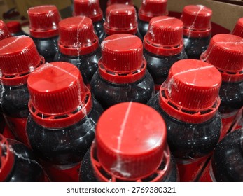 rows of red and black bottles lined up neatly in the shop