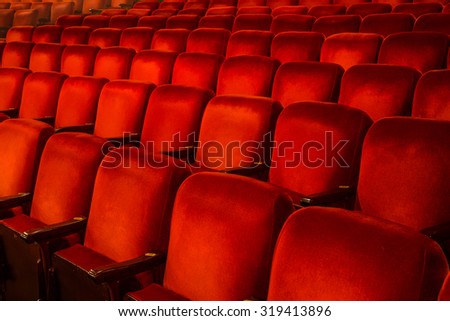 Rows of Red Chairs inside a theatre with copy space