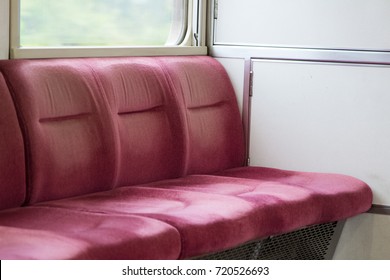 Rows of red empty seats on local train
