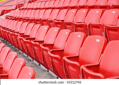 Rows Of Red Football Stadium Seats With Numbers.