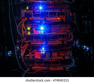 Rows of red network cables connected to router and switch hub in server room at internet data center