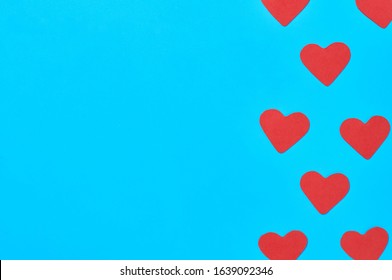 Rows of red paper hearts on blue background. Concept of Valentines Day. Space for text. Top view - Shutterstock ID 1639092346