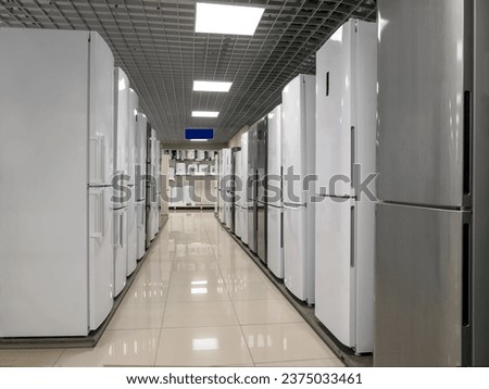Rows of refrigerators in a home appliance and electronics store. The choice of refrigerators for buyers. Modern household appliances