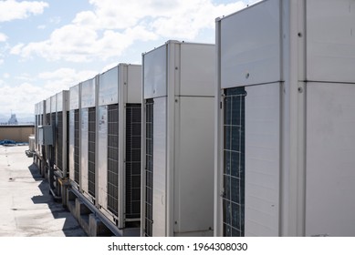 Rows of rooftop HVACs on the roofdeck of an office tower. VRF air conditioner for commercial buildings