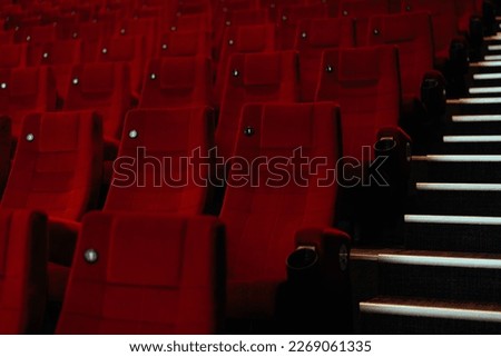 Rows of seats in an empty movie theater.
