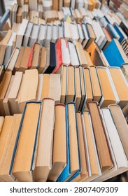 Rows of second hand books displayed for sale outside a street bookstore, affordable reading, literature, education, sustainable consumption and local culture concept