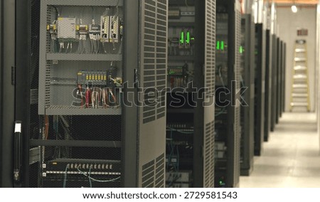 Rows of server racks in a data centre room, which is a physical facility that houses computer servers, IT infrastructure, and network equipment.