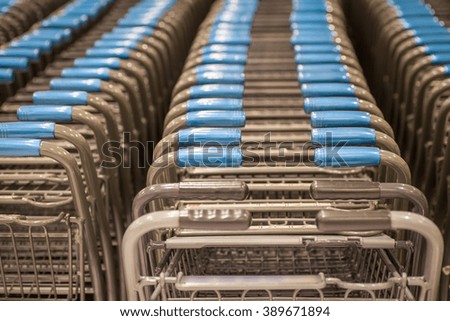 Rows of shopping carts at supermarket entrance

