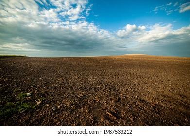 Rows of soil before planting. Furrows row pattern in a plowed field prepared for planting crops in spring. view of land prepared for planting and cultivating the crop. - Shutterstock ID 1987533212