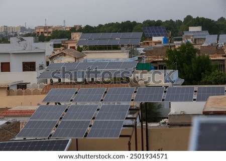 Rows of solar panels are being used to provide clean energy to homes in a crowded, impoverished neighborhood