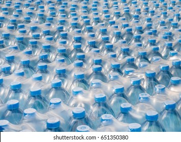 Rows of stacked plastic water bottles, Packaging of products piled in the factory area to prepare for sale. - Shutterstock ID 651350380