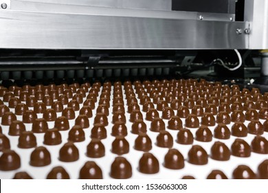 Rows Of Toppings For Chocolates Manufactured By Machine, On A Conveyor Of A Chocolate Factory 