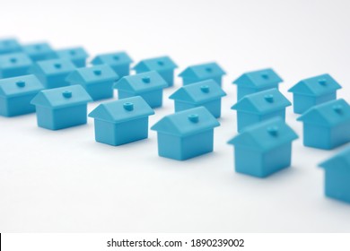 Rows Of Toy Blue Houses. Miniature Houses Arranged In Three Rows. Model Cottage Settlement. Miniature Homes. Many Small Houses. Real Estate In Cottage Village. Model City Neighborhood Property Market