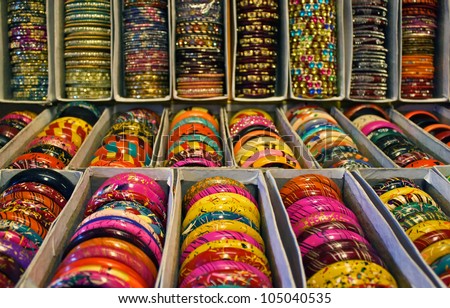 Rows of traditional Indian bangles with different colors and patterns.