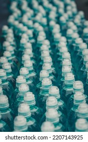 Rows Of Water Bottle. Lots Of Water Bottles. Bottles With White Caps. Simple Means Perfect. Merchandise Supplied To Supermarkets. Water For Marathon Runners