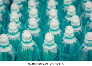 Rows Of Water Bottle. Lots Of Water Bottles. Bottles With White Caps. Simple Means Perfect. Merchandise Supplied To Supermarkets. Water For Marathon Runners