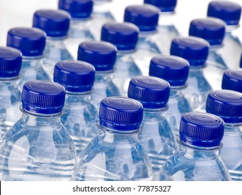 Rows of water bottles isolated on white background