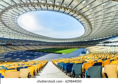 rows of yellow and blue stadium seats on soccer field stadium - Powered by Shutterstock
