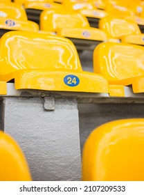 Rows Of Yellow Plastic Chairs In Stadium - Empty Seats At Sporting Event - Epidemic And Lockdown, Social Distancing