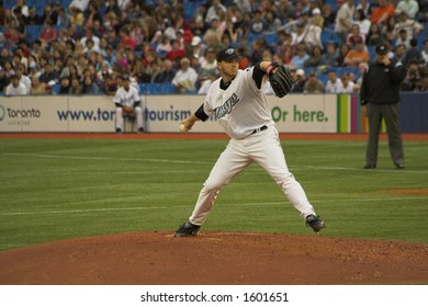 Roy Halladay Prepares To Pitch; Umpire Seen In The Background