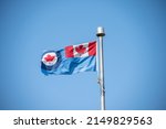 Royal Canadian Air Force (RCAF) flag on blue sky.