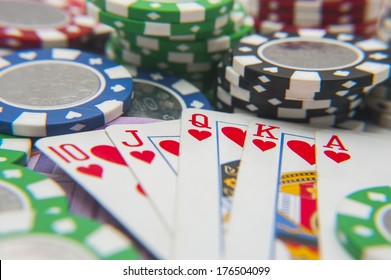 Royal flush poker hand with poker chips stack