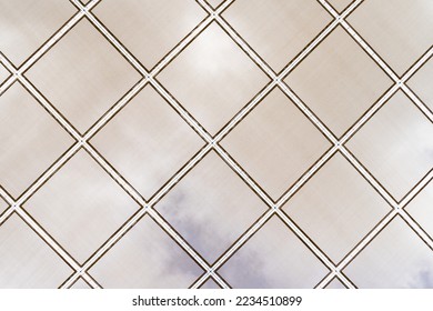 Royal geometric pattern background, rhombus roof with cloudy sky in the background. Canvas to protect from the symmetrical sun.