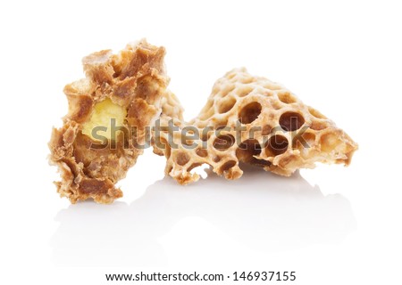 Royal jelly in honeycomb isolated on white background. Beauty and antiaging concept. Organic and natural cosmetics.