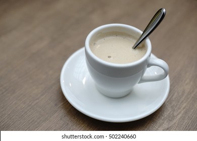 Royal Milk Tea Inside White Cup On The Wooden Table