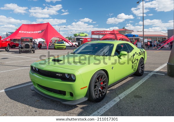 ROYAL OAK, MI/USA - AUGUST 14, 2014: A 2015 Dodge\
Challenger SRT Hemi Hellcat car, two Dodge Challengers, and a Viper\
at the Woodward Dream Cruise, the world\'s largest one-day\
automotive event. 