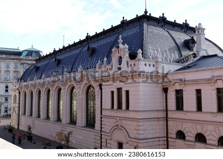 the Royal Riding Hall in the castle district in Budapest in perspective view. stucco exterior wall with colorful large arched windows and stone ornaments. enamel clay tile covered mansard roof. travel
