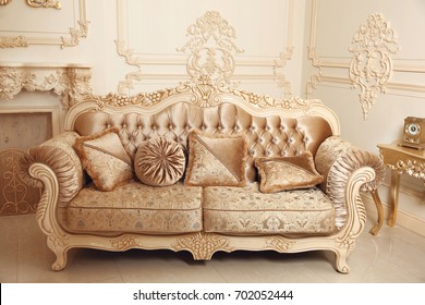 Royal Sofa With Pillows In Beige Luxurious Interior With Ornament Frame Wall